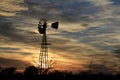 Kansas Awesome Sunset with colorful clouds, and a farm Windmill silhouette .