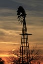 Kansas Awesome Sunset with colorful clouds, and a farm Windmill silhouette .