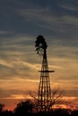 Kansas Awesome Sunset with colorful clouds, and a farm Windmill silhouette . Royalty Free Stock Photo