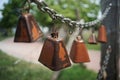 Closeup shot of old weathered rusty metal cowbells on a chain