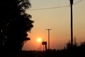 Kansas colorful Smokey Sunset with power lines and a country mail box. Royalty Free Stock Photo