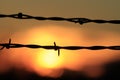 Kansas colorful Sunset with a barbwire fence silhouette with the Sun Royalty Free Stock Photo