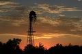 Kansas Blazing Sunset with a Windmill Silhouette and colorful sky Royalty Free Stock Photo