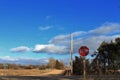 Kansas Country Road with blue sky,clouds, and a stop sign. Royalty Free Stock Photo