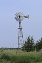 Kansas Windmill with blue sky with grass and trees out in the country