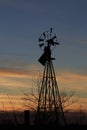 Kansas Windmill silhouette at Sunset with a colorful sky and clouds