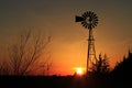 Kansas Windmill sunset with a tree silhouette with a colorful sky