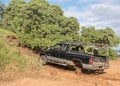 Abandoned truck on Kauai beach being towed