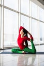Kapotasana. Beautiful yoga woman practice in a big window hall