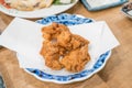 Karaage; Japanese Chicken fried in white dish on paper and on lay on wood table