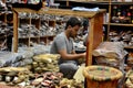 Reflection of hand made leather shoe salesman in mirror surrounded by shoes Karachi Pakistan