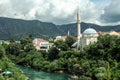 Karadjozbegova mosque seen from its opposite bank of the river Neretva in Mostar, Bosnia and Herzegovina.