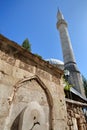 Karadoz Bey Mosque, located on Brace Fejica street, with a fountain and carvings in the foreground Royalty Free Stock Photo