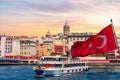 Karakoy pier, a ferry, Turkish flag and the Galata Tower in the background, Istanbul, Turkey