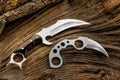 Karambit knives designer made, on the tree trunk