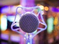 Karaoke dynamic microphone on colorful background in the club close up Royalty Free Stock Photo