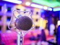 Karaoke dynamic microphone on colorful background in the club close up Royalty Free Stock Photo