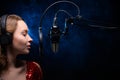 Karaoke, a female vocalist sings into a microphone. Vocal and study of singing, more developed voices and training, more developed