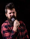 Karaoke man sings song to microphone, singer with beard