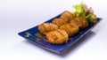 Karaoke with miso dressing and potato croquettes on blue chinese Royalty Free Stock Photo