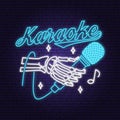 Karaoke neon poster, banner. Neon sign, emblem, bright signboard, light banner with skeleton hand and microphone. Vector Royalty Free Stock Photo