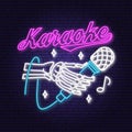 Karaoke neon poster, banner. Neon sign, emblem, bright signboard, light banner with skeleton hand and microphone. Vector Royalty Free Stock Photo