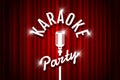 Karaoke party night live show open mic on empty theatre stage. Vintage microphone against red gradient curtain drape