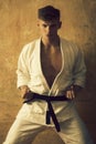 Karate or aikido man training in white kimono, black belt Royalty Free Stock Photo