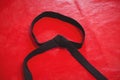 Karate black belt on red background