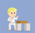 Karate boy getting ready to break the wood