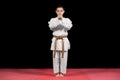 Karate boy in white kimono fighting isolated on black background Royalty Free Stock Photo