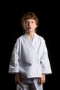 Karate boy in white kimono isolated on black Royalty Free Stock Photo