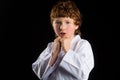 Karate boy in white kimono isolated on black Royalty Free Stock Photo