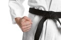 Karate coach wearing kimono and black belt on white background, closeup