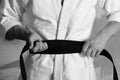 Karate fighter with fit strong hands gets ready to fight.