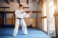 Karate Fighter practises fight in martial arts gym Royalty Free Stock Photo