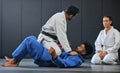 Karate, fitness and martial arts instructor teaching a lesson on fighting and defense training at a gym or indoor center