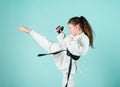 Karate gives feeling of confidence. Strong and confident kid. She is dangerous. Girl little child in white kimono with Royalty Free Stock Photo