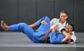 Karate, judo and aikido fighters fighting to win in martial arts fight competition to train or practice skills. Winning Royalty Free Stock Photo