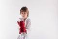 Karate kid wearing kimono and red boxing gloves Royalty Free Stock Photo