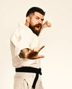Karate man with angry face in uniform. Oriental sports concept.
