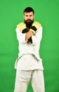 Karate man with serious face in uniform and boxing gloves Royalty Free Stock Photo