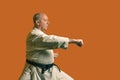 A karate man in a white kimono with a black belt is training. Royalty Free Stock Photo