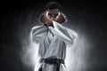 Karate martial arts fighter on dark background Royalty Free Stock Photo