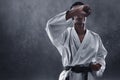 Karate martial arts fighter on dark background Royalty Free Stock Photo