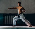 Karate martial arts fighter in white kimono in the gym