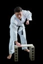 Karate player breaking wooden plank