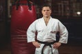 Karate player with hands on hips standing in fitness studio Royalty Free Stock Photo