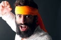 Karate portrait with angry expression posing against grey background