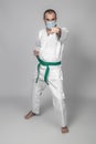 Karate practitioner wears a protective mask